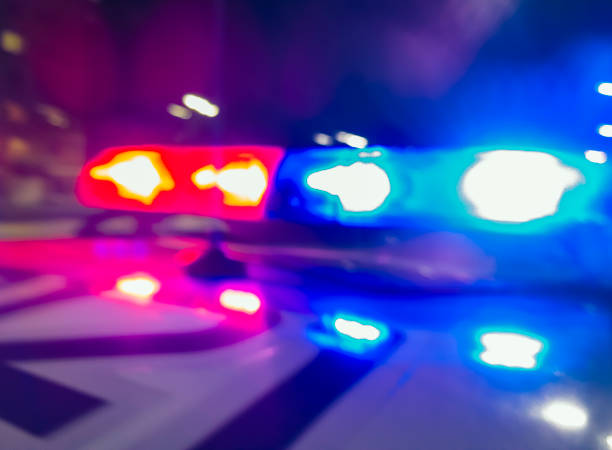 Police car lights in night time, crime scene, night patrolling the city. Abstract blurry image. stock photo