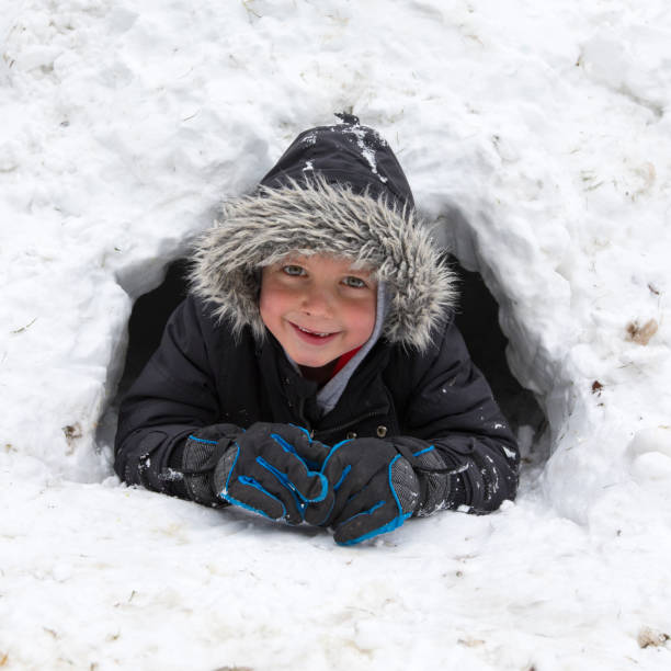 istock Young five year old boy in his igloo in winter, UK 943700162