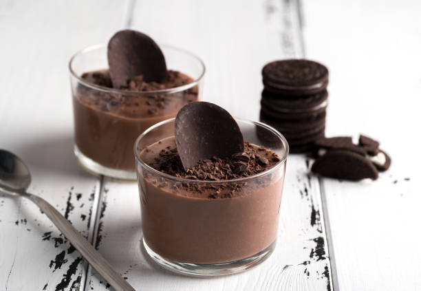 istock Chocolate mousse in a glasses on a white wood background. 943706026