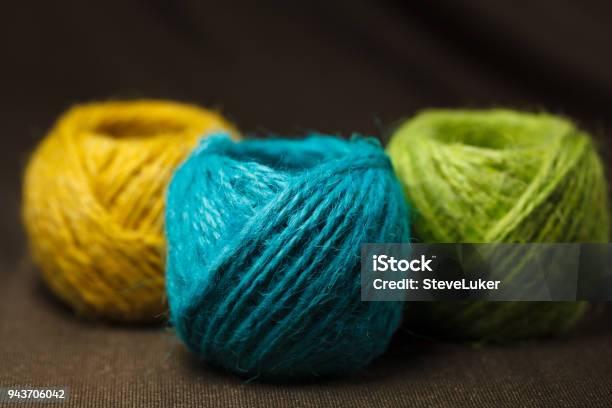 Three Colorful Balls Of Hemp Cotton A Brown Surface Stock Photo - Download Image Now