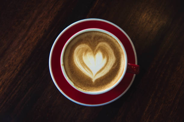 istock the red cup coffee love , coffee dark in wood dark table 943709230