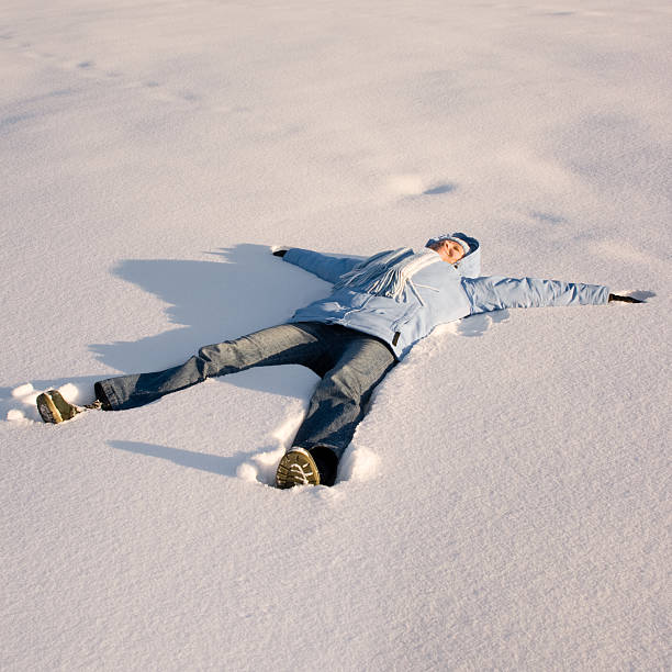 istock Happy young girl  lying in the snow 94371031