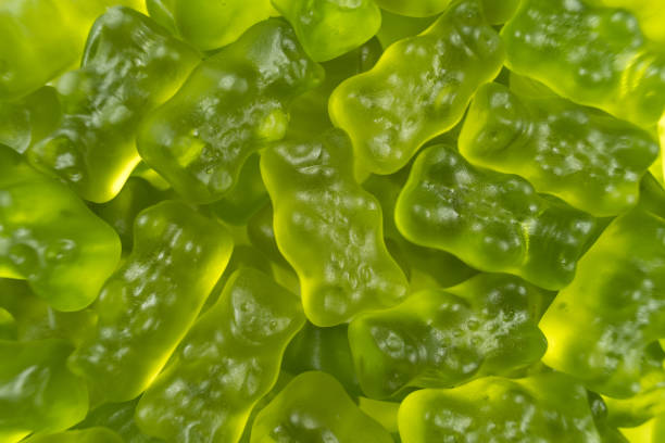 Green jelly babies / gummy bear candy sweets Green jelly babies / gummy bear candy sweets. Potential use as a background. gummi bears stock pictures, royalty-free photos & images