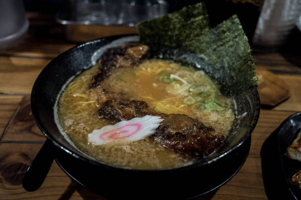 istock Pork Rib Ramen in black bowl with seaweed and a naruto 943716006
