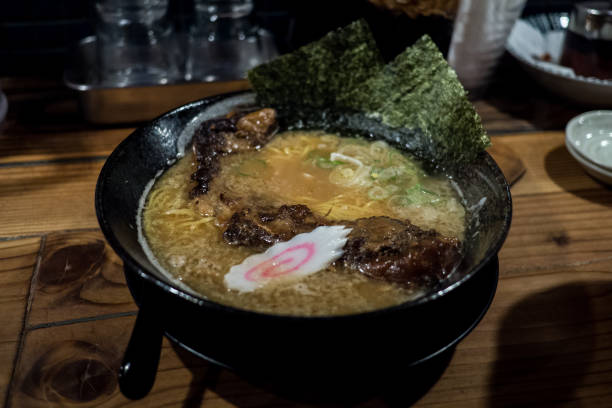 istock Pork Rib Ramen in black bowl with seaweed and a naruto 943716012