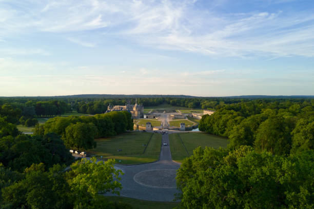 Chantilly, France - July 05 2017: Carrefour des Lions with in the background, the Chantilly castle surrounded by the woods.