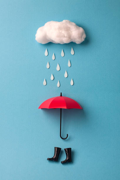 paraguas y la lluvia botas debajo de la nube sobre fondo azul de cielo - handmade umbrella fotografías e imágenes de stock