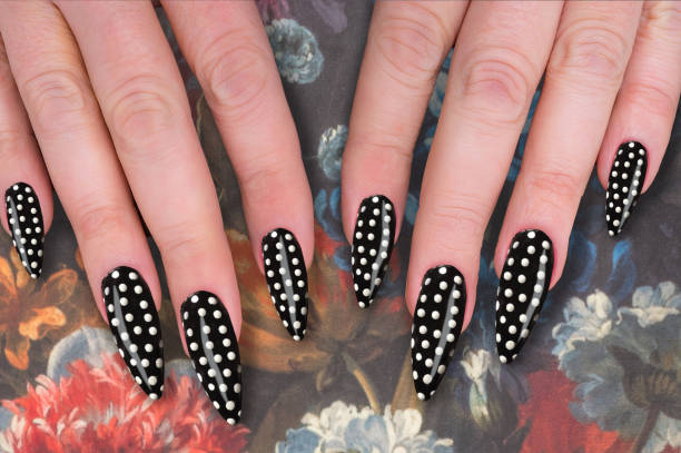 istock White on black polkadot polish on long black nails 943723662