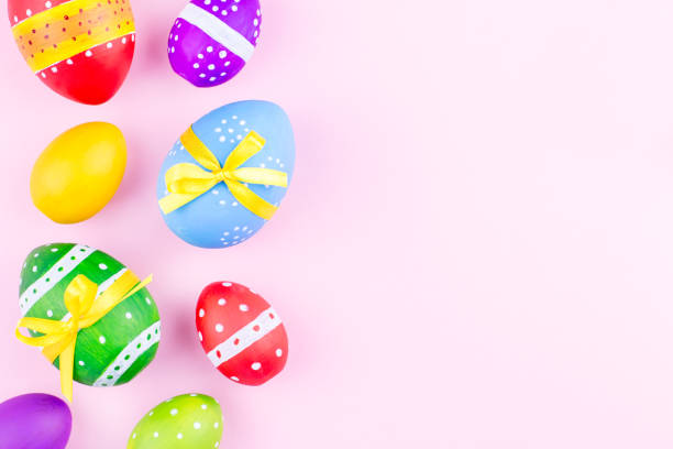 istock Colorful easter eggs on pink pastel background flat lay. Copy space 943726926