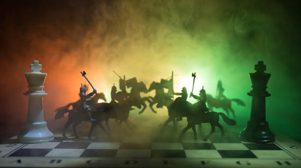 istock Medieval battle scene with cavalry and infantry on chessboard. Chess board game concept of business ideas and competition and strategy ideas Chess figures on a dark background. Selective focus 943729712