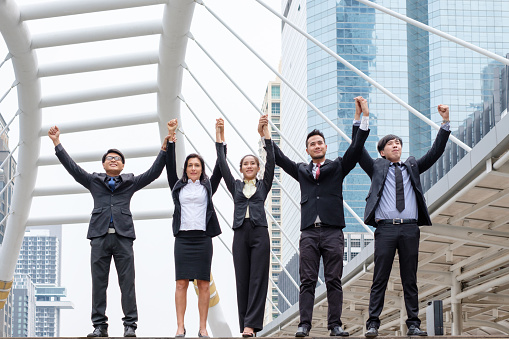 Professional group business person arm raised up are happiness with successful