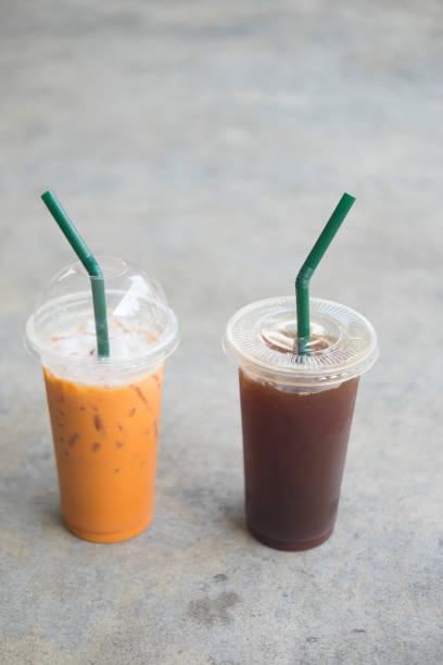 istock Close up iced Thai tea and iced black coffee in plastic cup 943735968