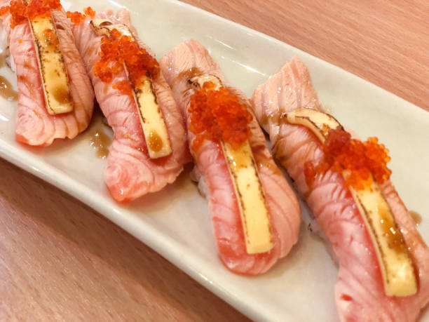 istock Grilling on salmon sushi on white dish 943735984