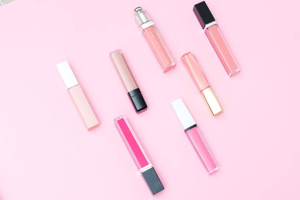 istock Women's lip gloss set for make-up on a pink background. Geometric style 943736262