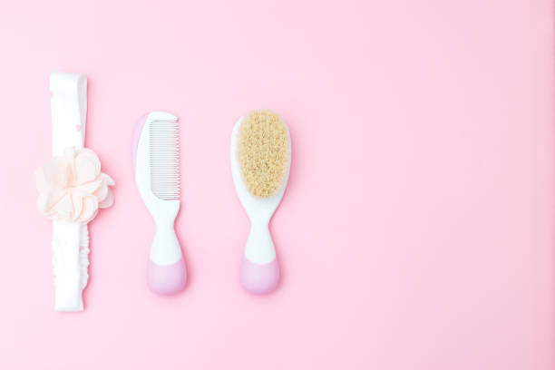 istock Baby headband and 
brush on pink background. Copy space 943739476