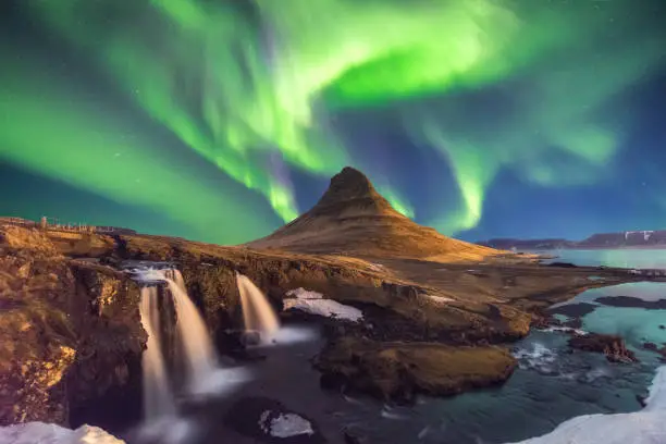 A wonderful night with Kp 5 . Northern lights mountain Kirkjufell in Iceland.