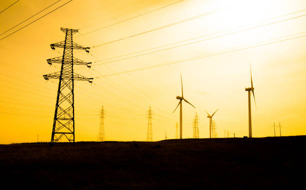 istock Wind turbines with pylon at sunset 943743992