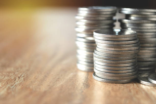 istock accounting concept with coins pen note book and calculator on table. 943753804