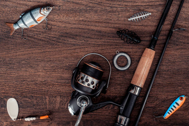 istock Fishing accessories on a wooden table. 943755174