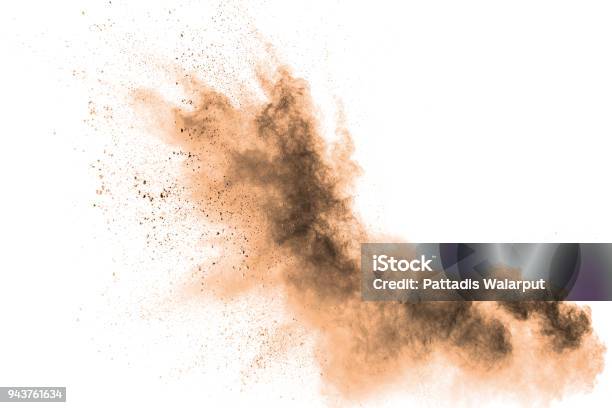 Abstract Brown Colored Sand Splash On White Background Color Dust Explode On Background By Throwing Freeze Stop Motion Stock Photo - Download Image Now