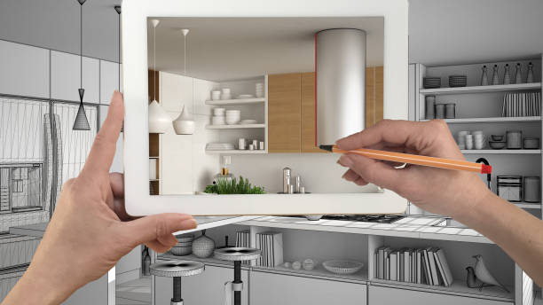 istock Hands holding and drawing on tablet showing real finished minimalist white and wooden kitchen. Modern kitchen sketch in the background, architecture interior design presentation 943765012