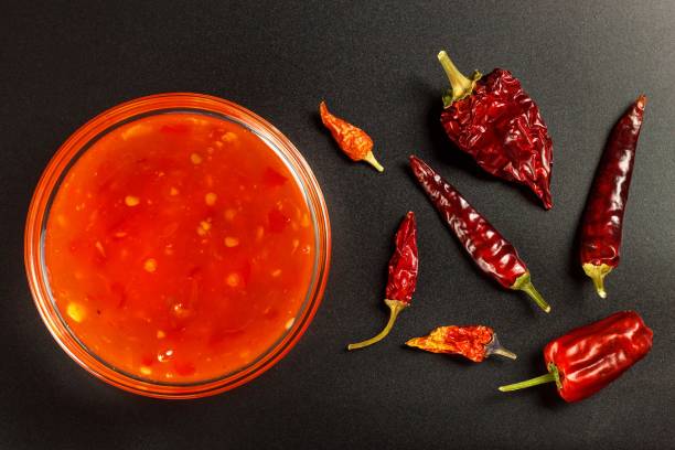 Sauce made of peppers. Preparation of spicy food. Healthy food. On a black background. Sauce made of peppers. Preparation of spicy food. Healthy food. On a black background spicery stock pictures, royalty-free photos & images