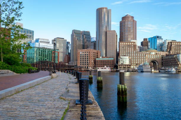 Fan Pier section of Harborwalk paved with sett stone South Boston, Massachusetts, USA - June 9, 2016: Section of the 43-mile Harborwalk runs along Fan Pier and overlooks Rowes Wharf harborwalk stock pictures, royalty-free photos & images