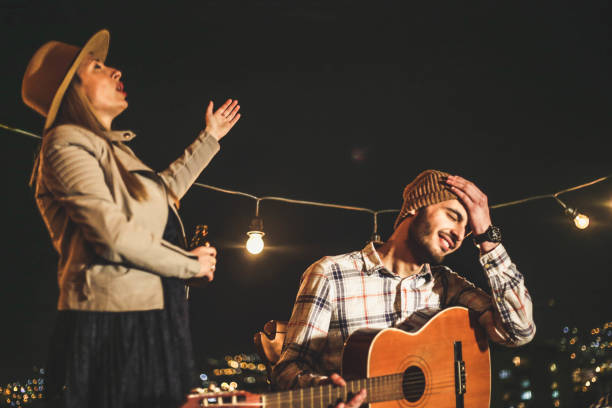 A girl and a guy with a guitar