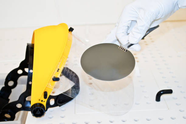 istock Female Scientist Working on Silicon Wafer Fabrication in Cleanroom 943772342