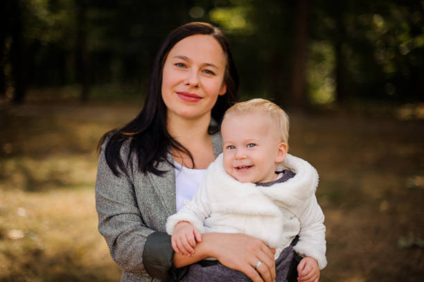 istock Smiling brunette mother with a cute little daughter 943772582