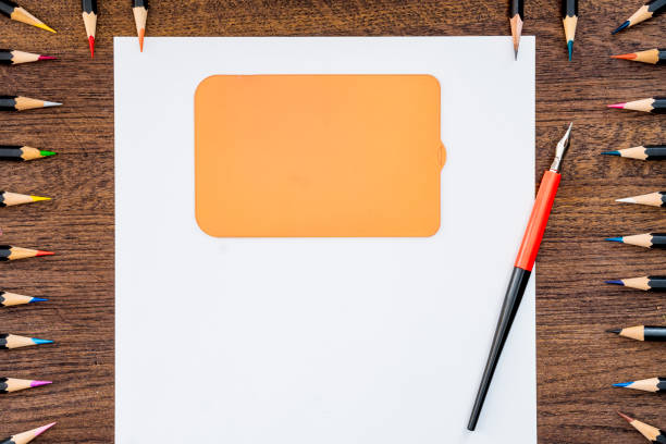 Frame from school supplies on a wooden background.