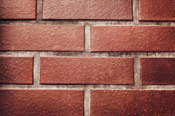 Photo of Red brick wall background. Texture of a stone wall. Close-up of bricks