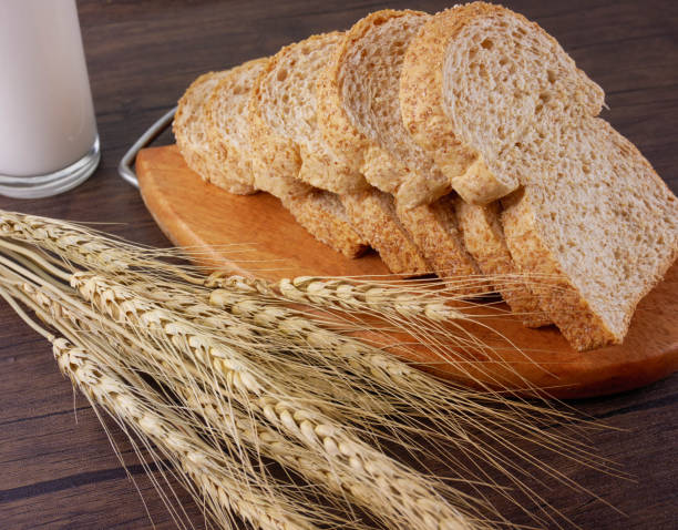 istock Whole wheat breads on wooden background 943775956