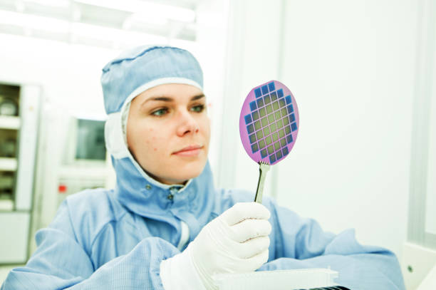 Female Scientist Working on Silicon Wafer Fabrication in Cleanroom Silicon Wafer Under Cleanroom Fabrication photodiode stock pictures, royalty-free photos & images