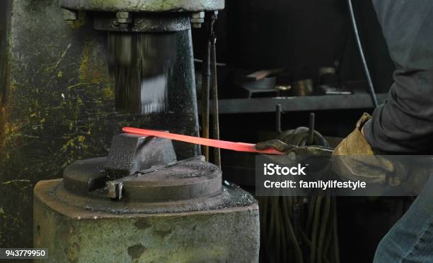 Using Pneumatic Hammer To Shape Hot Metal Making The Sword Out Of Metal Stock Photo - Download Image Now
