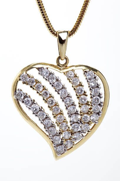 istock Golden heart shaped necklace with stones over white background 94378071