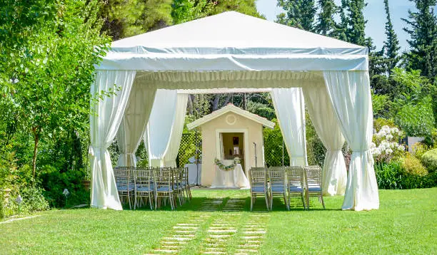 Photo of Outdoor reception under tents and trees