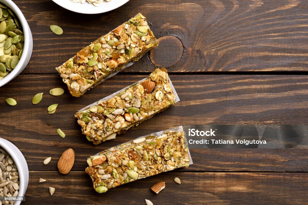 Granola bar. Healthy snack No baked granola bar on wooden background with copy space. Energy natural snack. Top view, flat lay Protein Bar Stock Photo