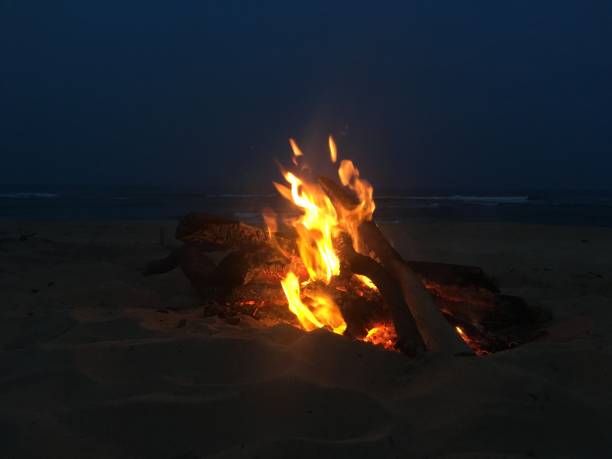 istock Fire on Beach during Full Moon Rising in Spring on Kauai Island, Hawaii. 943786580