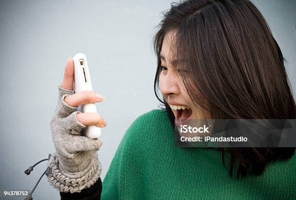 Girl Using A Cell Phone Stock Photo - Download Image Now - Adult, Anger, Black Hair
