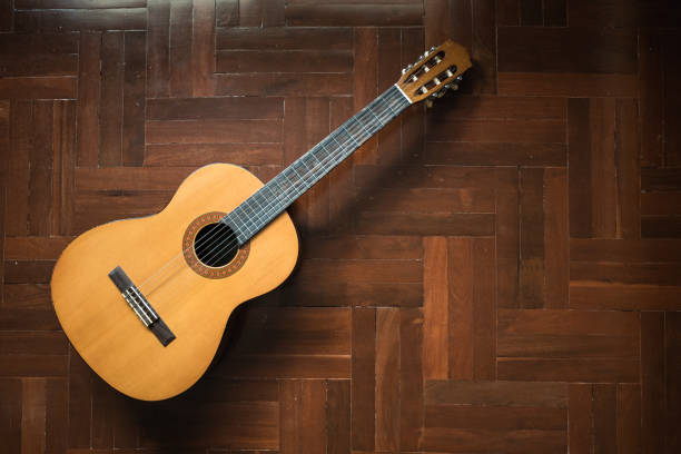 istock Classical Guitar on wooden floor 943791998