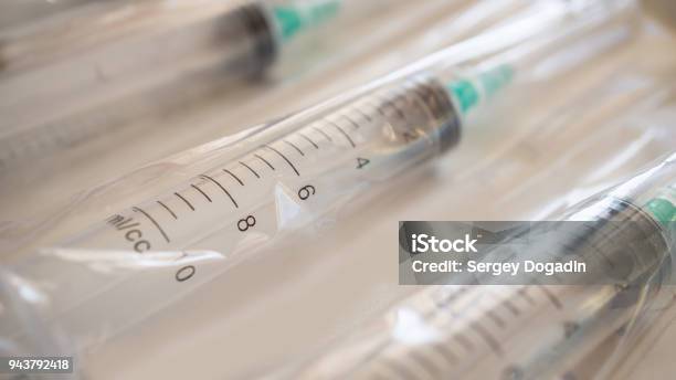 Disposable Plastic Syringes With Needles In The Package Macro Shot Stock Photo - Download Image Now