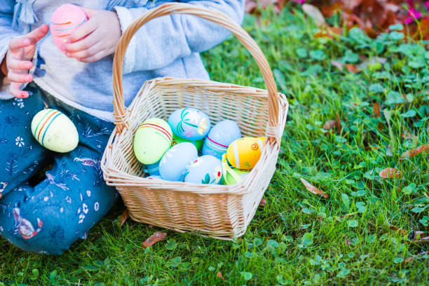 istock Closeup basket full of colorful Easter eggs in kids hands 943800852