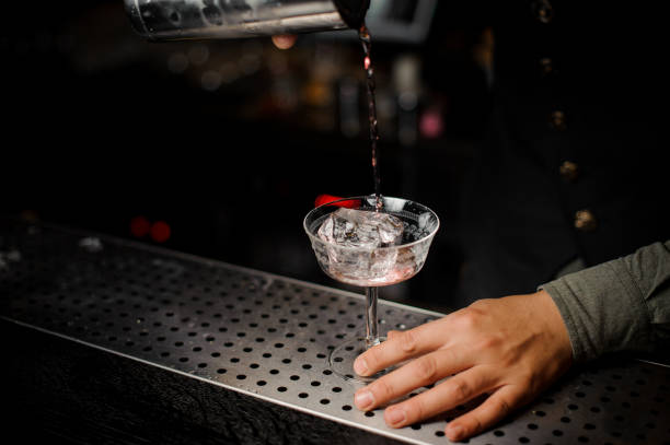 istock Barman pouring a cocktail with campari into a glass 943800886