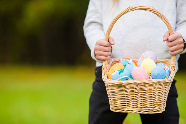 istock Closeup basket full of colorful Easter eggs in kids hands 943801090