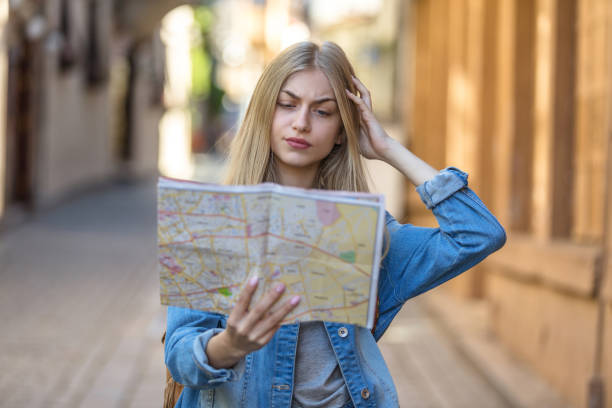 istock Young tourist in the city looking a map 943803402