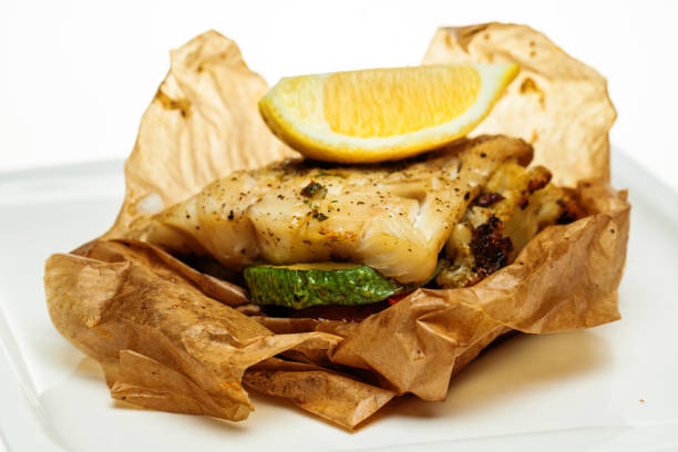 istock Cod fish fillet closeup. Grilled cod fish with vegetable. Healthy Diet Food 943804398