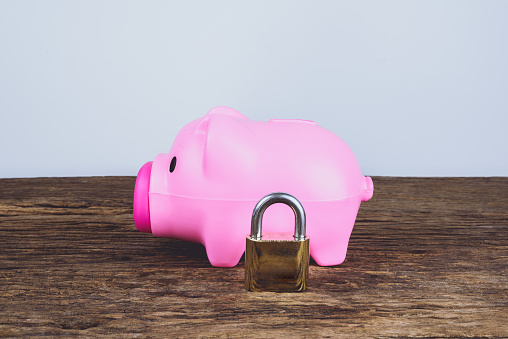 A pink piggybank and lock. Save Money Concept and used for financial protection inferences or other investment messages