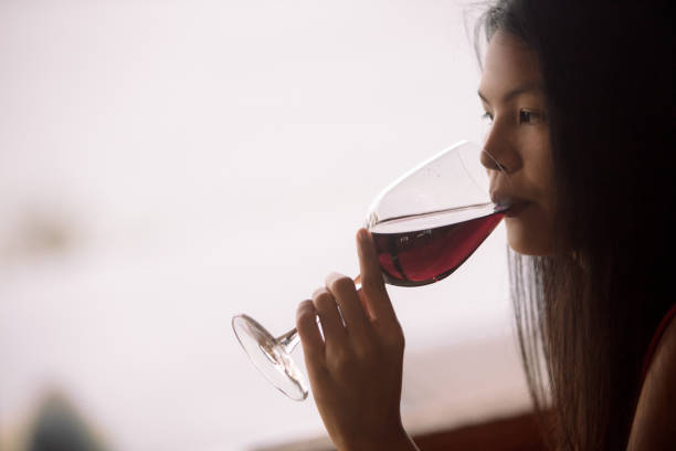 istock Asian woman drinking red wine 943815862