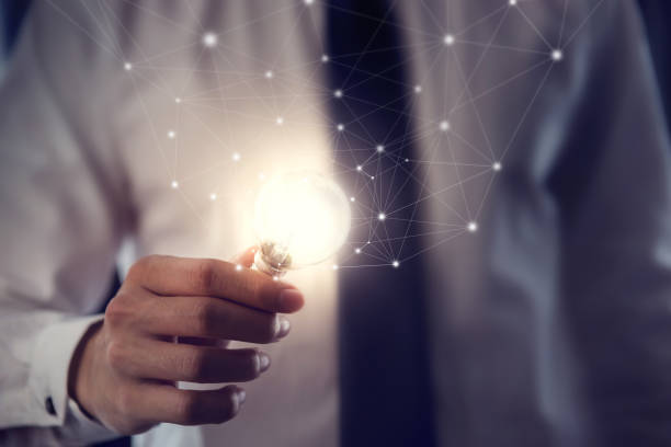 istock Businessman holding illuminated light bulb, idea, innovation and inspiration concept. 943815956